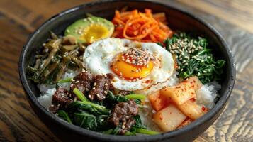A Bowl of Bibimbap with Fried Egg, Beef, and Vegetables photo