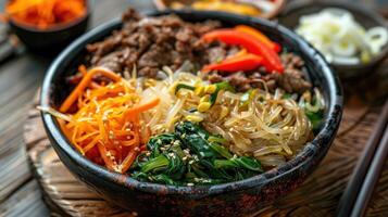 A Bowl of Bibimbap with Beef, Vegetables, and Sesame Seeds photo