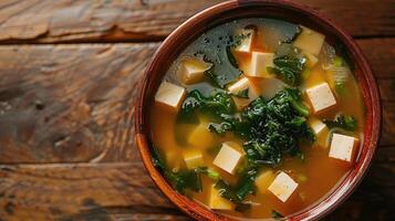 Bowl of miso soup with tofu and seaweed photo