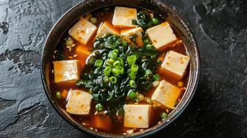 Bowl of Miso Soup with Tofu, Seaweed, and Green Onions photo