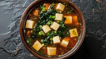 Bowl of Miso Soup with Tofu, Spinach, and Green Onions photo