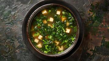 Bowl of Miso Soup with Tofu, Seaweed, and Green Onions photo