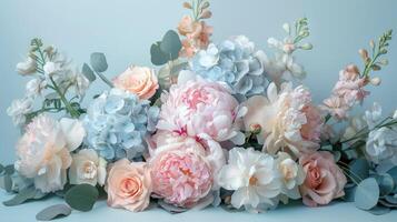 Pastel Flowers and Eucalyptus on a Light Blue Background photo