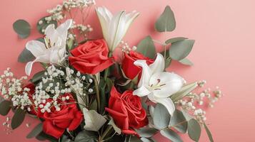 Bouquet of Red Roses, White Lilies, and Baby's Breath on Pink Background photo