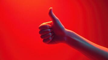 A Hand Giving a Thumbs Up Against a Red Background photo