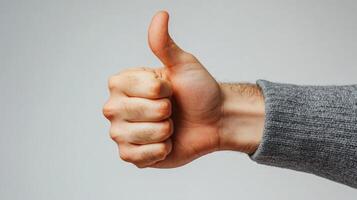 A Hand Giving a Thumbs-Up Gesture photo