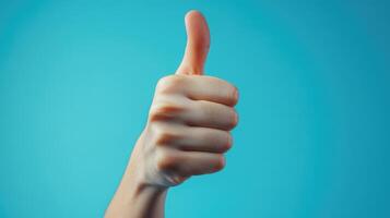 A Thumbs Up Gesture Against a Blue Background photo
