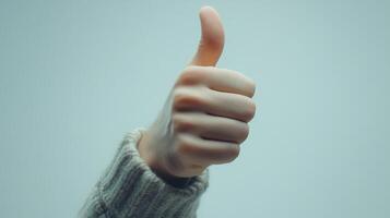 Closeup of a Hand Giving a Thumbs Up Gesture photo