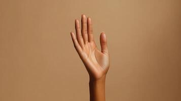 A Close-Up View of an Open Hand Against a Light Brown Background photo
