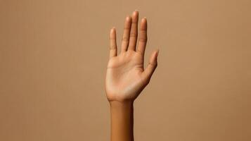 Open Hand with Spread Fingers Against a Tan Background photo