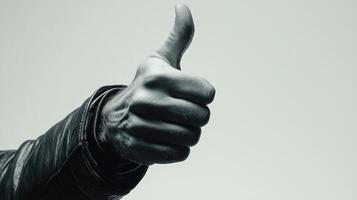 Close-up of a Man's Hand Giving a Thumbs Up in Black and White photo