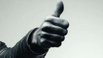 Close-up of a Hand Giving a Thumbs Up, Wearing a Leather Jacket photo