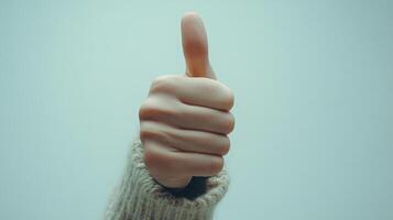 A Close-Up of a Hand Giving a Thumbs-Up Gesture photo