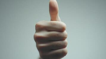 Close-up of a thumb giving a thumbs-up gesture photo