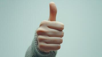 A Close-Up of a Hand Giving a Thumbs-Up Gesture photo
