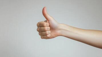 A Close-Up of a Hand Giving a Thumbs-Up Gesture photo