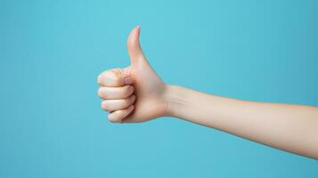 A Hand Giving a Thumbs Up Gesture Against a Blue Background photo