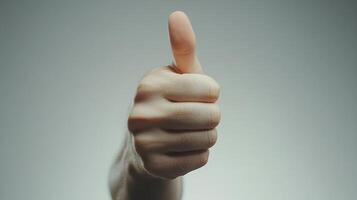 Close-up of a Person's Thumbs-Up Gesture photo