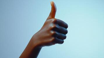 A Person's Hand Giving a Thumbs Up Gesture photo