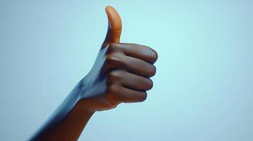 Close-up of a Hand Giving a Thumbs Up Gesture photo