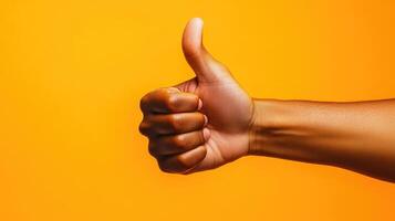 A Hand Giving a Thumbs Up Gesture Against a Yellow Background photo