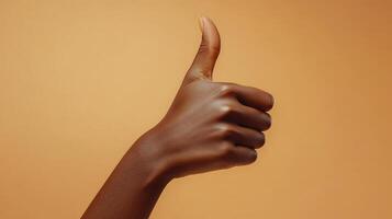 A Close-up of a Person's Hand Giving a Thumbs-Up Gesture photo