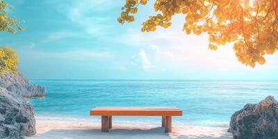 Wooden Bench on a Sandy Beach with a Turquoise Ocean and Yellow Tree Branches photo