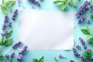 White Paper Surrounded by Lavender Flowers and Green Leaves on a Blue Background photo