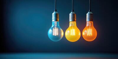 Three Light Bulbs Hanging Against a Blue Background photo