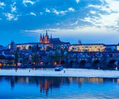 View of Charles Bridge and Prague Castle in dusk photo
