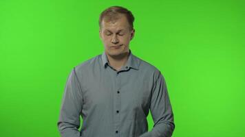 Sleepy bored guy looking at camera not interested in communication. Man on chroma key background video