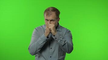 Funny handsome guy trying to fight at camera, boxing with expression. Man on chroma key background video