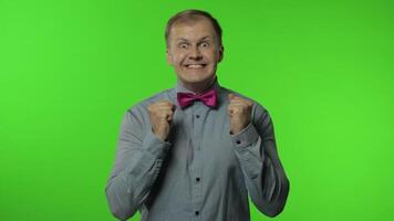Enthusiastic excited happy man raising hands in victorious gesture, dancing shouting. Chroma key video