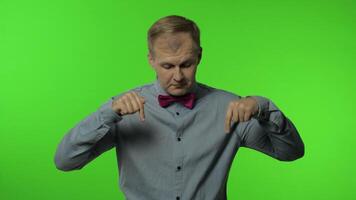 Man asking to subscribe, trying to control, pointing fingers down. Guy on chroma key background video