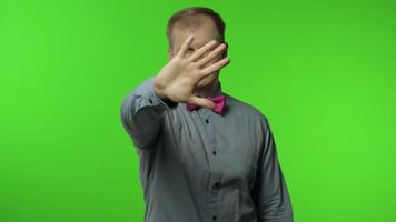 Man raising hand warning of danger, showing stop gesture, protecting from danger. Telling to stop video