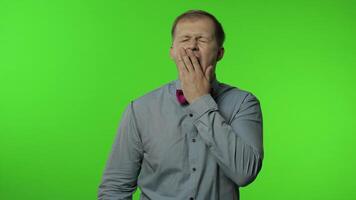 Tired man yawning and stretching hands, waking up, dreaming of rest, feeling lazy drowsy, insomnia video
