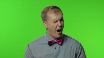 Comical man making silly face with inflates the cheeks, idiotic expression, grimace, fooling around video