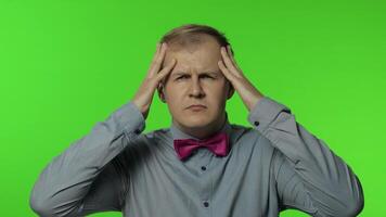 Flu-sick man feeling unwell, suffering headache, rubbing head to relieve pain, migraine, stress video