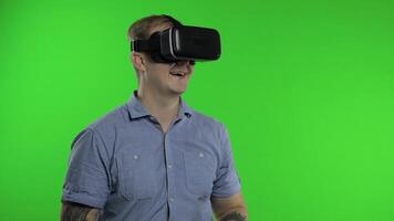 Man using VR headset helmet to play game. Watching virtual reality 3d 360 . Chroma key video