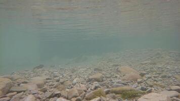 Underwater Rocky Bed in Mountains photo