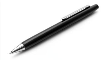A close-up view of a black ballpoint pen on a clean white surface photo
