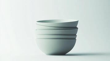 A stack of minimalist ceramic bowls arranged artistically on a neutral background photo