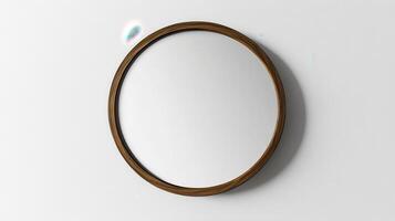 A simple round mirror with a wooden frame hanging on a white wall in a bright room photo