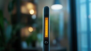A digital measuring tool with an illuminated scale, captured indoors during evening hours photo