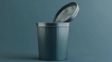 Metal waste bin with an open lid set against a blue background photo