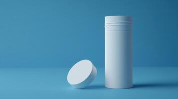 Minimalist white container with a lid resting beside it against a blue background photo