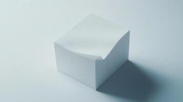 A minimalistic white block sits on a light surface, showcasing its smooth texture under soft lighting photo