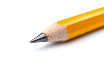 Close-up of a sharpened yellow pencil on a white background showcasing its fine point and wooden texture photo