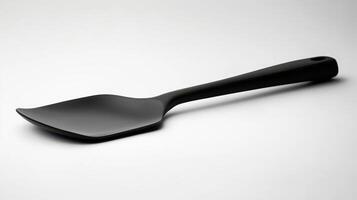 Black spatula resting on a neutral background, showcasing its sleek design and kitchen utility for cooking and serving food photo