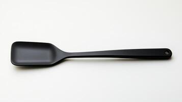 A simple black silicone spatula placed on a light surface in a well-lit kitchen environment photo
